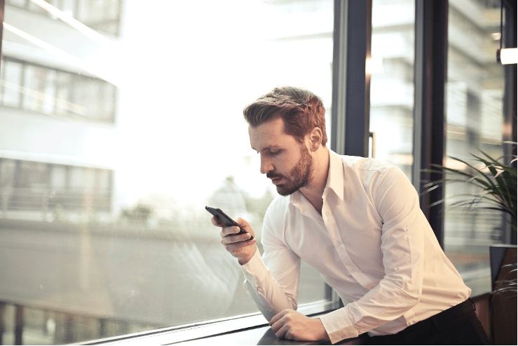 A man looking to his mobile phone